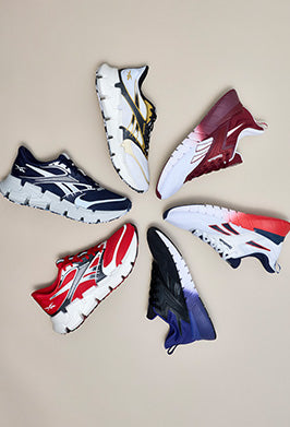 Six sneakers arranged in a pinwheel of various colors, from red and white to black and white
