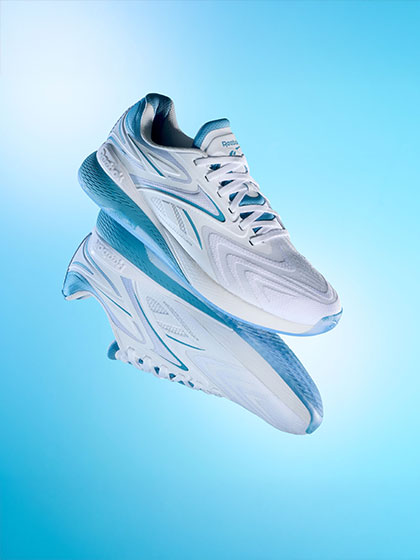 Blue and white sneakers on a light gradient blue background