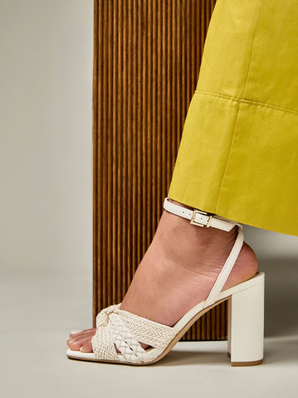 Close up of white heeled sandal