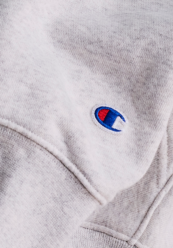 Close-up of Champion branded sweater with blue and red C logomark