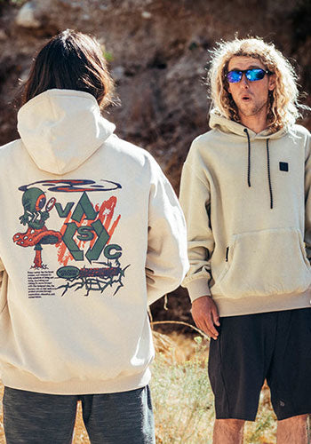 Two people in hoodies, one with their back facing the camera with a graphic on the back.